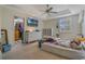 Bright bedroom features a ceiling fan, a large window, and an adjacent walk-in closet at 1188 Foxforrest Cir, Apopka, FL 32712