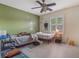 Bedroom showcasing a silver tree decal on a green wall, a ceiling fan, and shuttered windows at 1188 Foxforrest Cir, Apopka, FL 32712