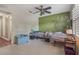 Bedroom featuring a silver tree decal on a green accent wall, ceiling fan, and shuttered windows at 1188 Foxforrest Cir, Apopka, FL 32712
