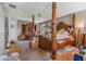 Spacious main bedroom featuring natural light, fan, and four poster bed at 1188 Foxforrest Cir, Apopka, FL 32712