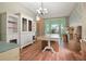 Dining room with wood floors, decorative walls, and moving boxes at 1188 Foxforrest Cir, Apopka, FL 32712