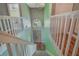 Staircase view overlooking the front door and foyer with chandelier, plus safety gate at 1188 Foxforrest Cir, Apopka, FL 32712