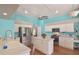 A modern kitchen featuring white cabinets, a center island, and stainless-steel appliances at 1188 Foxforrest Cir, Apopka, FL 32712