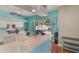 A bright kitchen with white cabinets, breakfast bar, and a sliding door to the screened patio at 1188 Foxforrest Cir, Apopka, FL 32712
