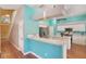Kitchen with white cabinets, breakfast bar, stainless appliances, and bright turquoise walls at 1188 Foxforrest Cir, Apopka, FL 32712