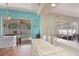 Bright kitchen featuring white countertops, a stainless steel faucet, and a view of the screened-in pool area at 1188 Foxforrest Cir, Apopka, FL 32712