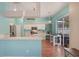 Bright kitchen with white cabinets, breakfast bar, stainless steel appliances, and sliding glass doors to the patio at 1188 Foxforrest Cir, Apopka, FL 32712