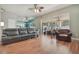 Spacious living room with sliding glass doors to the screened patio and an open view of the kitchen area at 1188 Foxforrest Cir, Apopka, FL 32712