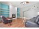 Open living area with fireplace, ceiling fan, and decorative bird art on the wall with comfortable furniture at 1188 Foxforrest Cir, Apopka, FL 32712