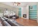 Bright living room featuring a fireplace, built-in shelving, ceiling fan and sliding glass doors to the patio at 1188 Foxforrest Cir, Apopka, FL 32712
