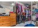 Bright walk-in closet with hanging racks, shelves, drawers, and space for organization at 1188 Foxforrest Cir, Apopka, FL 32712