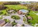 Aerial view of a community pool and recreation center with soccer fields, and a nearby pond at 12188 Ryegrass Trl, Orlando, FL 32824