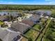 Aerial view of a residential community with lush greenery, a serene lake, and well-maintained homes at 12188 Ryegrass Trl, Orlando, FL 32824