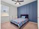 Stylish bedroom with a blue accent wall and a colorful bedspread at 12188 Ryegrass Trl, Orlando, FL 32824