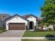 Charming single-story home featuring a well-manicured lawn, a brown two-car garage, and inviting curb appeal at 12188 Ryegrass Trl, Orlando, FL 32824