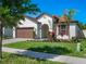 Charming one-story home with a brick driveway, a two-car garage and a well-manicured front yard at 12188 Ryegrass Trl, Orlando, FL 32824
