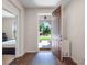 Inviting foyer featuring an open doorway, hardwood floors, and a view of the landscaped front yard at 12188 Ryegrass Trl, Orlando, FL 32824