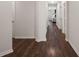 Long hallway with hardwood floors connecting various rooms of the house and doors on both sides at 12188 Ryegrass Trl, Orlando, FL 32824
