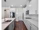 A modern kitchen features stainless steel appliances, white cabinets, and quartz countertops at 12188 Ryegrass Trl, Orlando, FL 32824