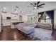 Open-concept living room and kitchen featuring hardwood floors, a ceiling fan, and recessed lighting at 12188 Ryegrass Trl, Orlando, FL 32824