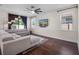Bright living room with hardwood floors, a ceiling fan and large windows at 12188 Ryegrass Trl, Orlando, FL 32824