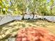 This backyard includes an outdoor patio, white fence and additional space at 1236 Illinois St, Orlando, FL 32803