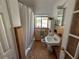 This bathroom has a tub with shower, mosaic tile floor, and window at 1236 Illinois St, Orlando, FL 32803