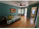 Bedroom with a daybed, hardwood floors, an adjacent bathroom, and access to the backyard at 1236 Illinois St, Orlando, FL 32803