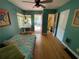 Bedroom with a daybed, hardwood floors, an adjacent bathroom, and backyard access at 1236 Illinois St, Orlando, FL 32803