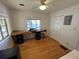 This home office includes hardwood floors, lots of natural light, and a ceiling fan at 1236 Illinois St, Orlando, FL 32803