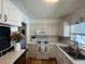 Bright kitchen with white cabinets, backsplash, and stainless steel sink at 1236 Illinois St, Orlando, FL 32803