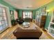 Charming living room featuring hardwood floors, turquoise walls, and a glass coffee table at 1236 Illinois St, Orlando, FL 32803