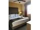 Inviting bedroom with a king-sized bed, bedside table, ceiling fan, and swan towel art at 12539 Floridays Resort Dr Dr # 208D, Orlando, FL 32821