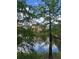 Exterior lake view through the trees of the community building at 12539 Floridays Resort Dr Dr # 208D, Orlando, FL 32821