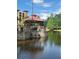 Scenic pond with a charming gazebo and beautiful water reflections at 12539 Floridays Resort Dr Dr # 208D, Orlando, FL 32821