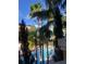 Picturesque view of a pool area with palm trees and resort buildings at 12539 Floridays Resort Dr Dr # 208D, Orlando, FL 32821