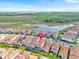 Overhead view of a residential area with a lake in the background at 13543 Abberwick Dr, Orlando, FL 32832