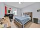 Comfortable bedroom featuring a wooden bed frame, a desk and a window with natural light at 13543 Abberwick Dr, Orlando, FL 32832