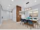 Dining area with a modern table, stylish chairs, and a contemporary light fixture, next to an accent wall at 13543 Abberwick Dr, Orlando, FL 32832