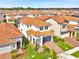 Beautiful two-story home boasts a gray garage door, lush landscaping and a terracotta roof at 13543 Abberwick Dr, Orlando, FL 32832
