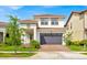 Charming two-story home with stucco exterior, tiled roof, and well-maintained landscaping at 13543 Abberwick Dr, Orlando, FL 32832