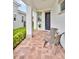 Inviting front porch with brick pavers, two chairs, a small table, and charming curb appeal at 13543 Abberwick Dr, Orlando, FL 32832