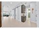 Open hallway featuring tile floors, a decorative cabinet, and access to the living areas at 13543 Abberwick Dr, Orlando, FL 32832