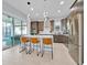 Modern kitchen with stainless steel appliances, island with seating, and sliding glass doors to the patio at 13543 Abberwick Dr, Orlando, FL 32832