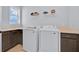 Clean laundry room with front-loading washer and dryer, offering convenience and functionality at 13543 Abberwick Dr, Orlando, FL 32832