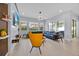 Bright living room with large windows, stylish furniture, and an open floor plan with light wood-look tile at 13543 Abberwick Dr, Orlando, FL 32832