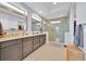 Main bathroom with a double sink vanity and glass enclosed shower at 13543 Abberwick Dr, Orlando, FL 32832