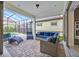 Covered patio with brick pavers and dark wicker furniture surrounding pool at 13543 Abberwick Dr, Orlando, FL 32832