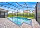 Screened in pool area with brick pavers and manicured shrubbery in backyard at 13543 Abberwick Dr, Orlando, FL 32832