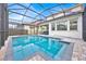 Sparkling screened-in pool surrounded by pavers, with comfortable seating and lush landscaping for relaxation at 13543 Abberwick Dr, Orlando, FL 32832